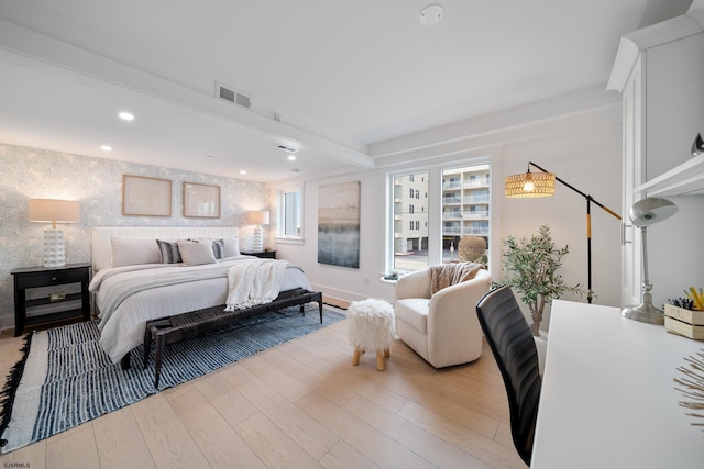bedroom with beam ceiling, recessed lighting, visible vents, light wood-style flooring, and wallpapered walls