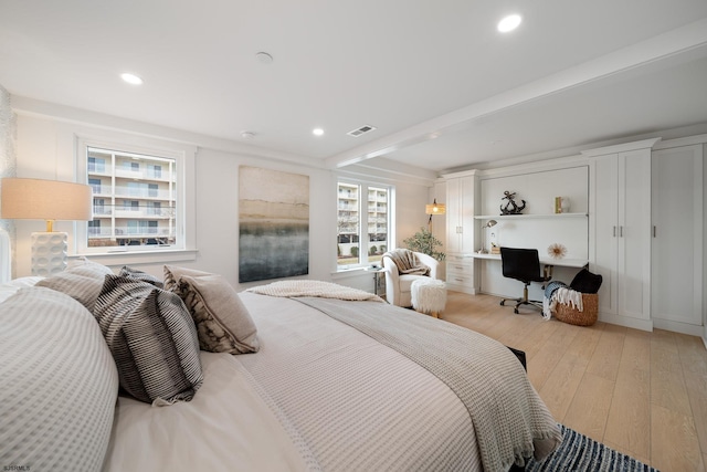bedroom featuring light wood-style floors, visible vents, beamed ceiling, and recessed lighting