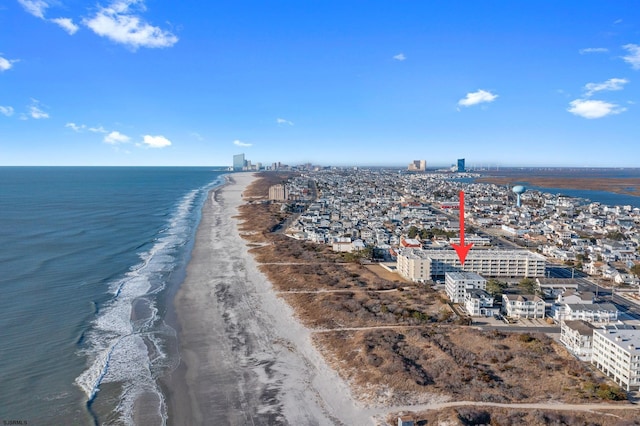 bird's eye view featuring a water view, a view of city, and a view of the beach