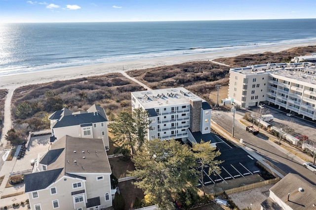 drone / aerial view with a water view and a beach view