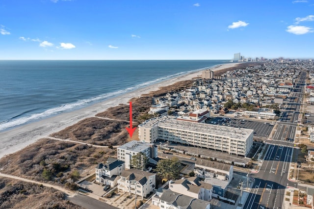 bird's eye view with a water view and a beach view