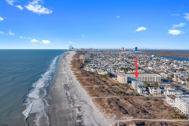 aerial view featuring a view of the beach, a water view, and a city view