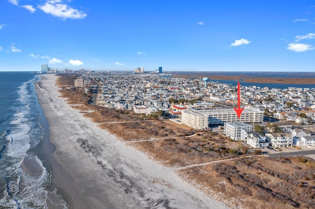aerial view with a water view, a view of city, and a beach view