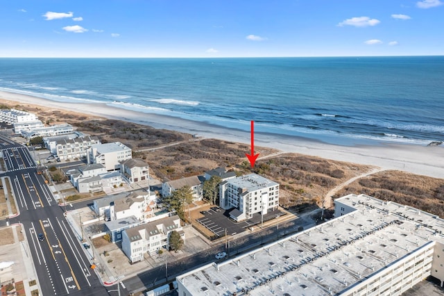 birds eye view of property with a water view and a view of the beach