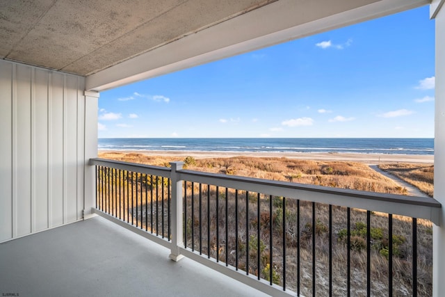 balcony featuring a water view and a view of the beach