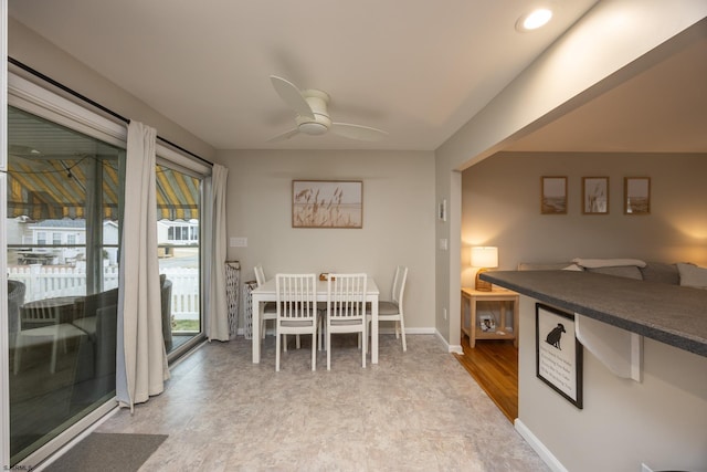 dining space featuring baseboards and a ceiling fan