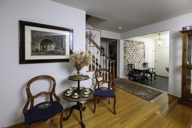 living area featuring stairway and wood finished floors