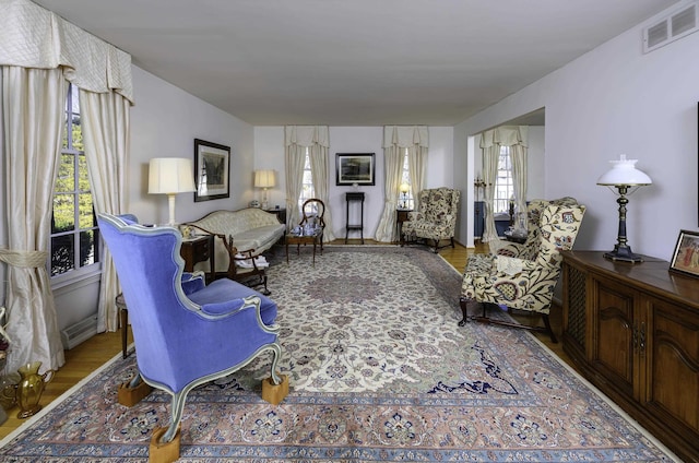 living room with visible vents and wood finished floors