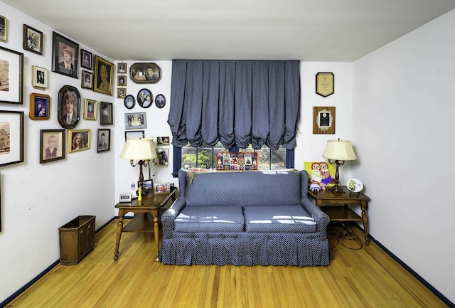 living area with wood finished floors and baseboards