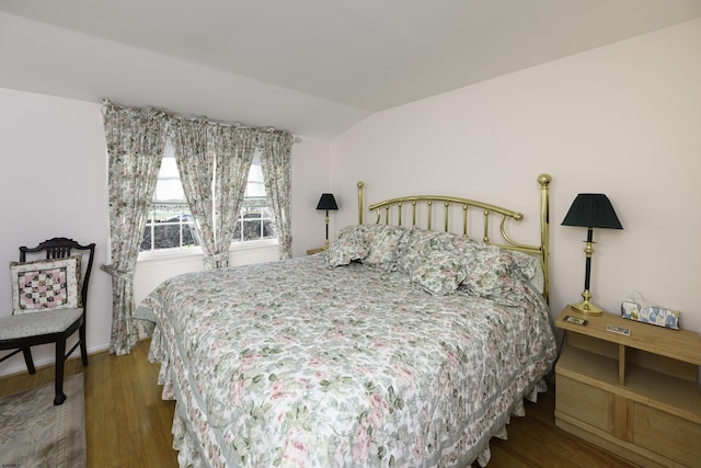 bedroom featuring vaulted ceiling and wood finished floors