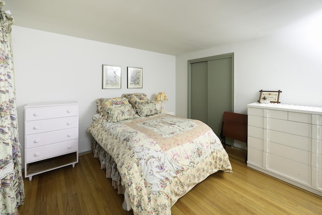 bedroom with a closet and wood finished floors