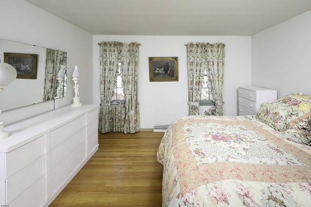 bedroom featuring light wood-type flooring and baseboard heating