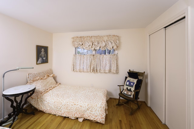 bedroom featuring a closet and wood finished floors