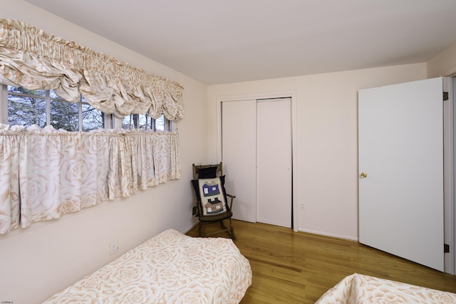 bedroom with a closet and wood finished floors