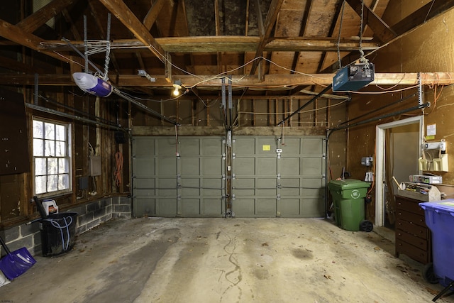 garage featuring electric panel and a garage door opener