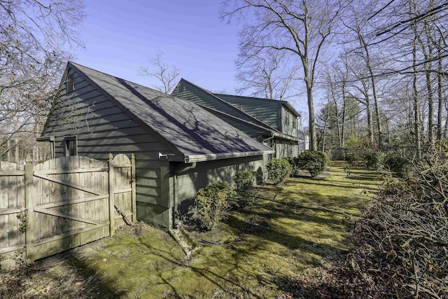 view of home's exterior featuring roof with shingles