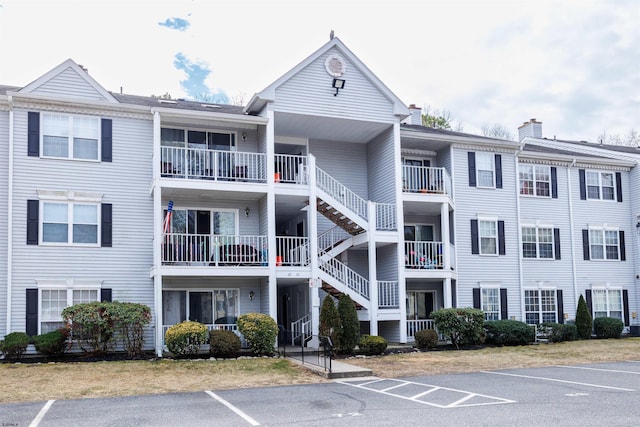 view of building exterior featuring uncovered parking