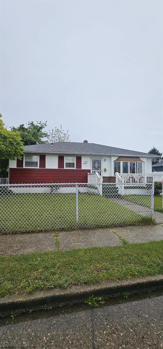 view of front of house with a fenced front yard and a front yard