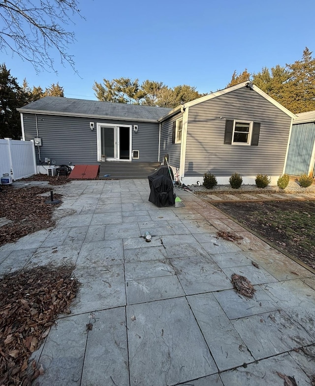 back of property featuring a patio and fence