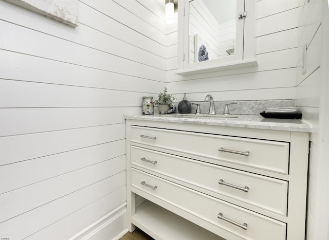 interior space featuring wooden walls and a sink