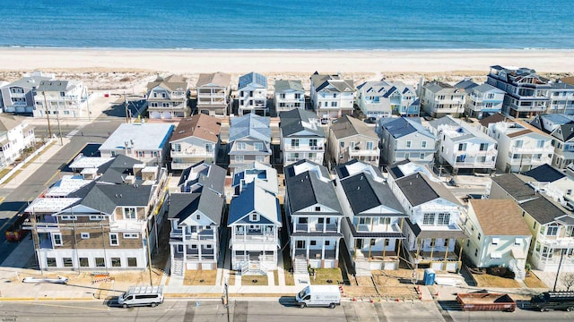 aerial view with a beach view, a residential view, and a water view