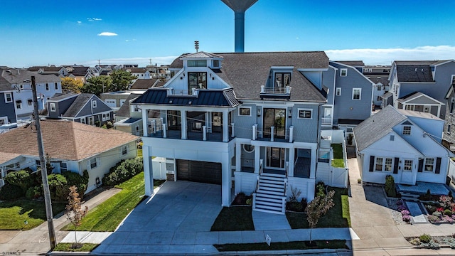 view of front of home featuring a residential view, a standing seam roof, metal roof, and a balcony