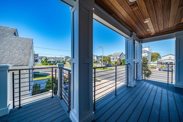 wooden terrace with a residential view