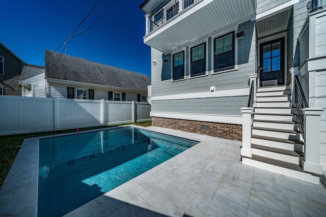 view of pool with a fenced in pool, a fenced backyard, and a patio