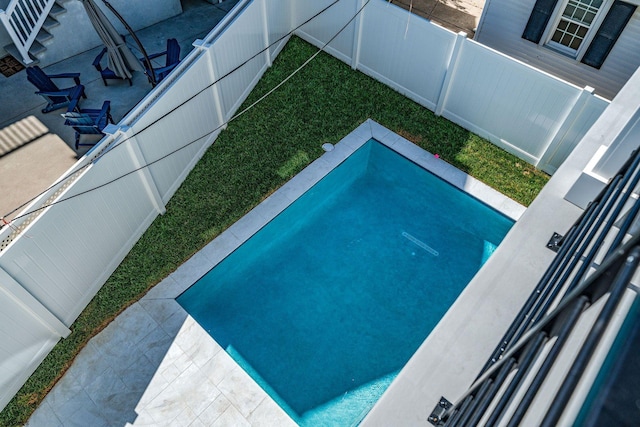 view of swimming pool featuring a patio area and a fenced backyard