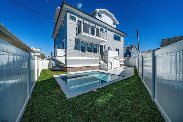 back of house with a yard and a fenced backyard