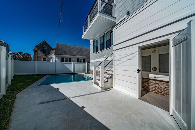 view of swimming pool featuring a fenced in pool, a fenced backyard, and a patio