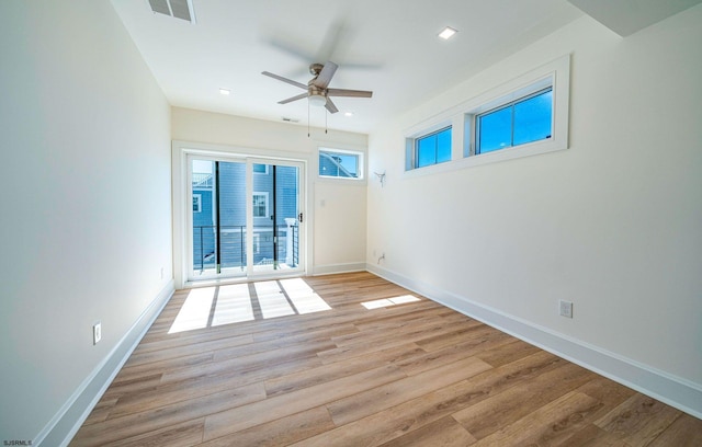 unfurnished room with baseboards, ceiling fan, visible vents, and light wood-style floors