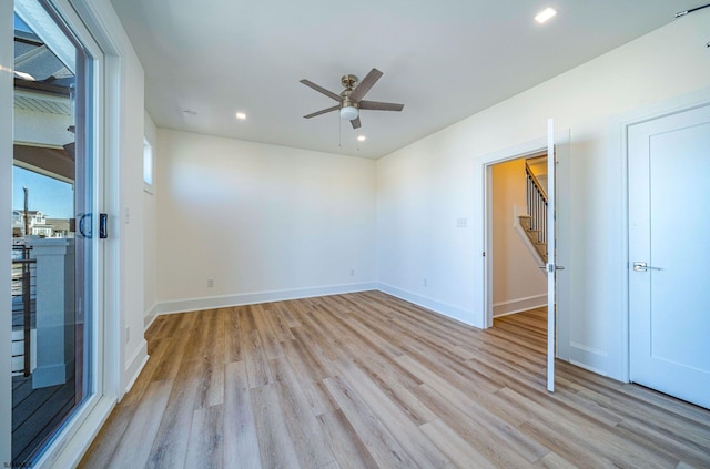 unfurnished room with recessed lighting, wood finished floors, and baseboards