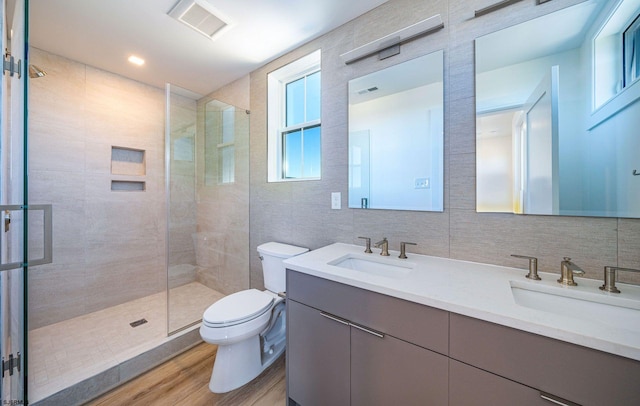 full bath featuring a sink, toilet, and a shower stall