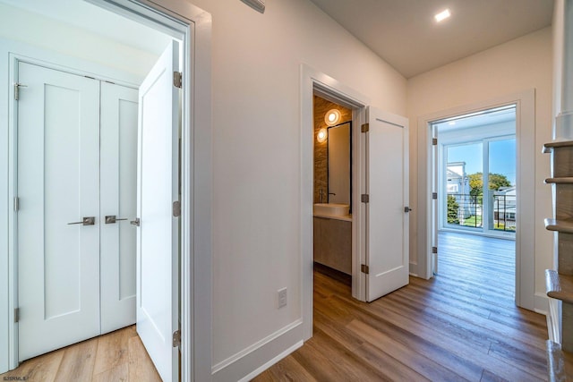 hall with wood finished floors and baseboards