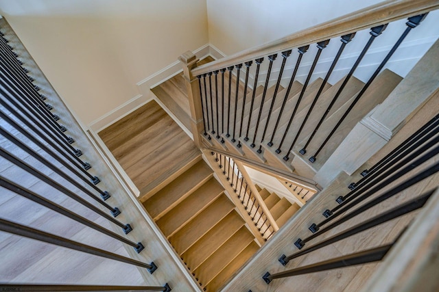 stairway featuring wood finished floors