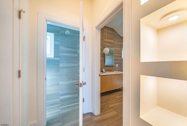 hallway featuring tile walls