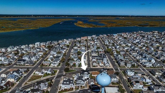 drone / aerial view with a residential view and a water view