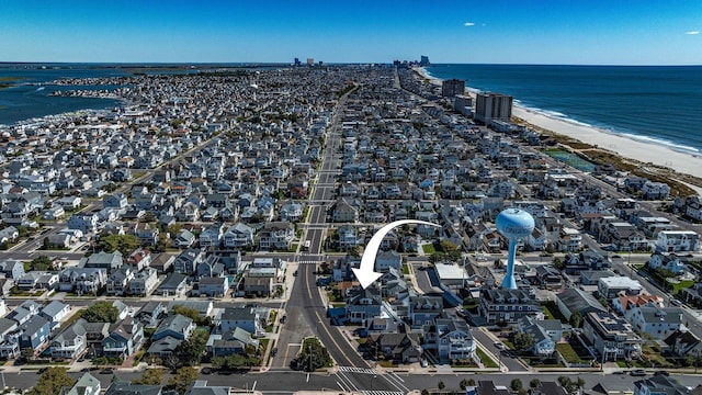 drone / aerial view with a water view and a view of the beach