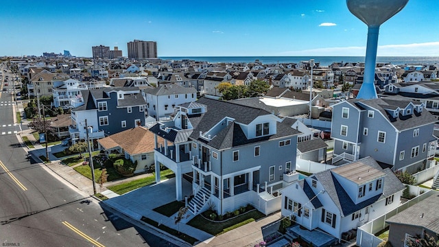 drone / aerial view with a water view and a residential view