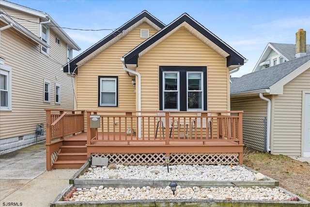 back of house featuring a deck