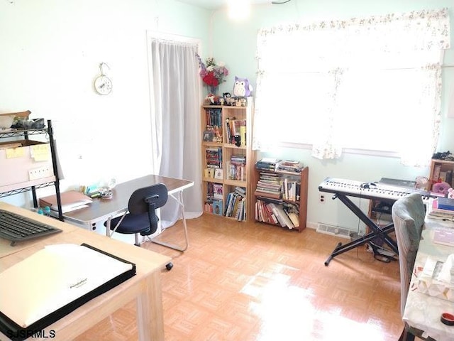 home office featuring plenty of natural light and an inviting chandelier