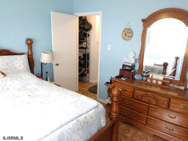 bedroom featuring a walk in closet