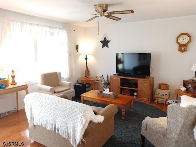 living room featuring a ceiling fan and light wood-style floors