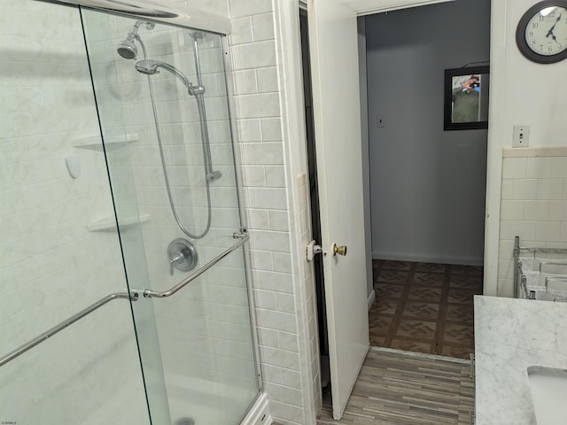 full bath featuring a stall shower and wood finished floors