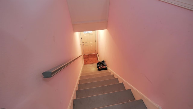 stairs with baseboards and wood finished floors