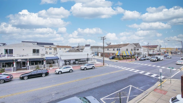 view of street featuring curbs, street lighting, and sidewalks