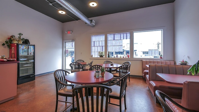 dining room featuring concrete floors and baseboards