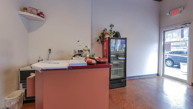 bar with finished concrete flooring and baseboards