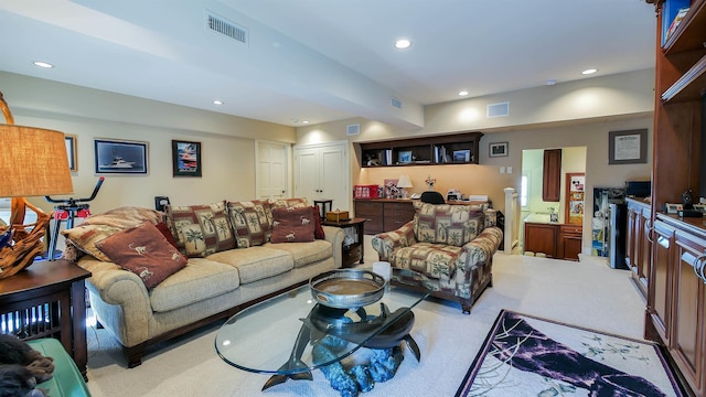 living area featuring visible vents and recessed lighting